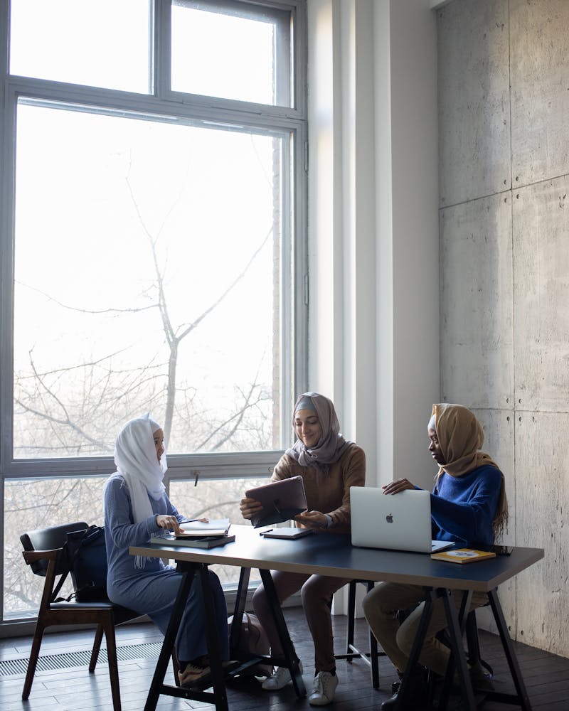 Teacher helping students with technology